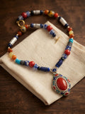 Tribal mosaic beaded necklace with cloisonné red coral pendant on linen pouch