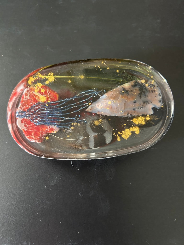 Arrowhead, Red Coral & Ceremonial Fringe Oval Resin Paperweight – Miniature World with flint arrowhead and navy bead fringe in dark charcoal resin
