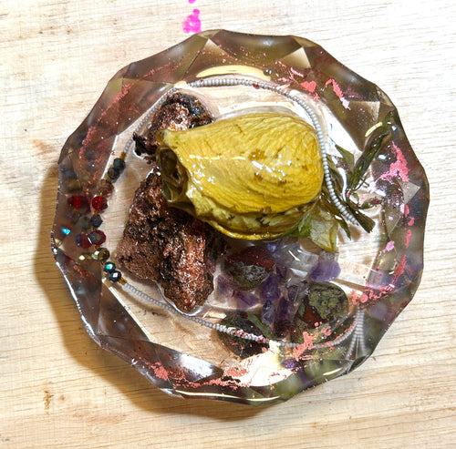 Copper Alchemy resin paperweight — overhead view showing resinized rose bud on raw copper ore, silver seed bead chain, amethyst clusters, garnet beads and dried botanicals in smoky copper-shimmer faceted diamond-edge resin disc