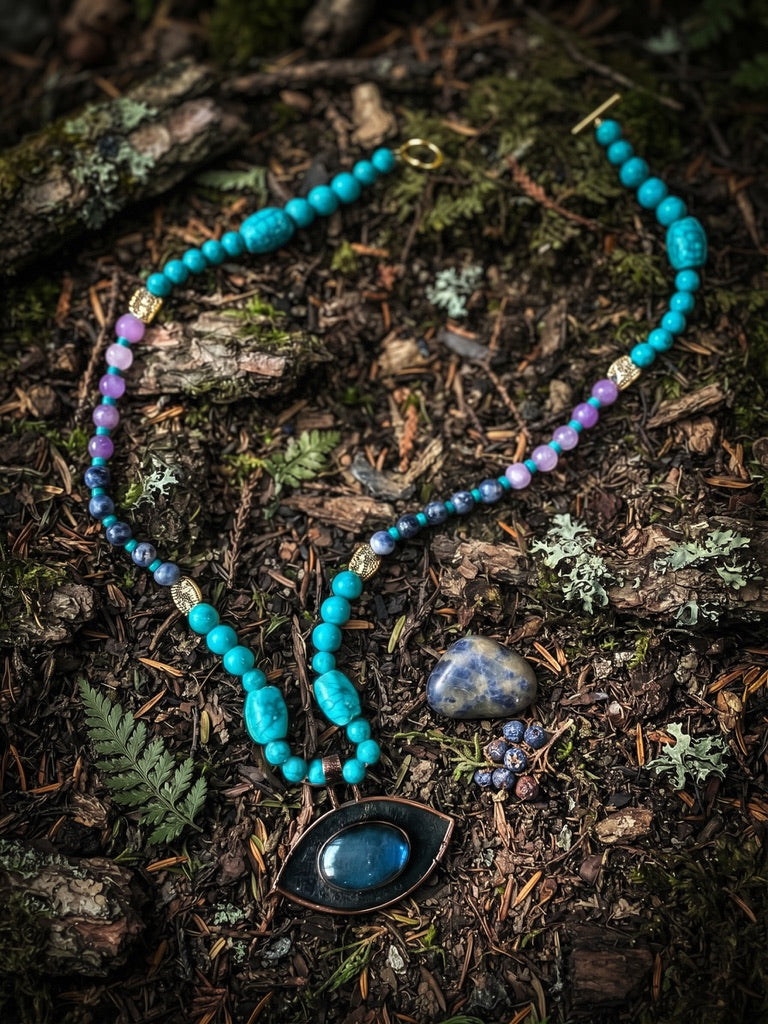 Whispers of the Forest turquoise amethyst lapis necklace with copper eye pendant on forest floor