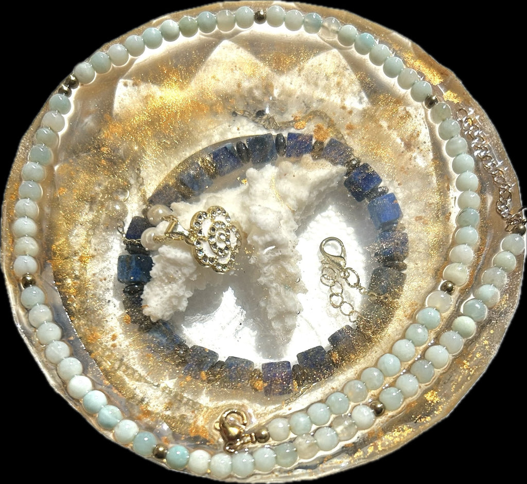 Azure Halo rounded paperweight with pale aqua bead strands, deep blue pieces, textured white forms, and golden shimmer