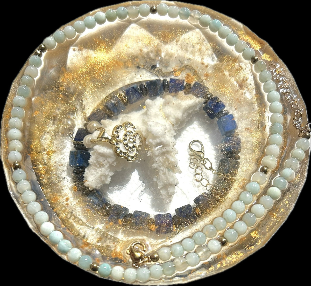 Azure Halo rounded paperweight with pale aqua bead strands, deep blue pieces, textured white forms, and golden shimmer