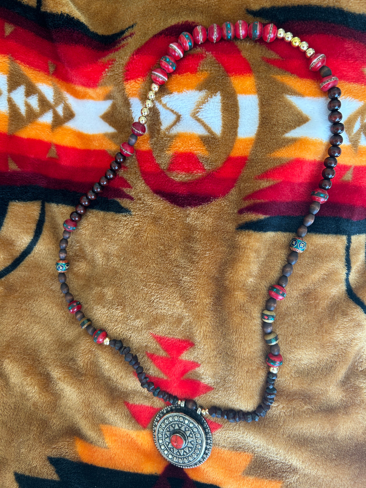 Earth and Ember necklace on tribal textile
