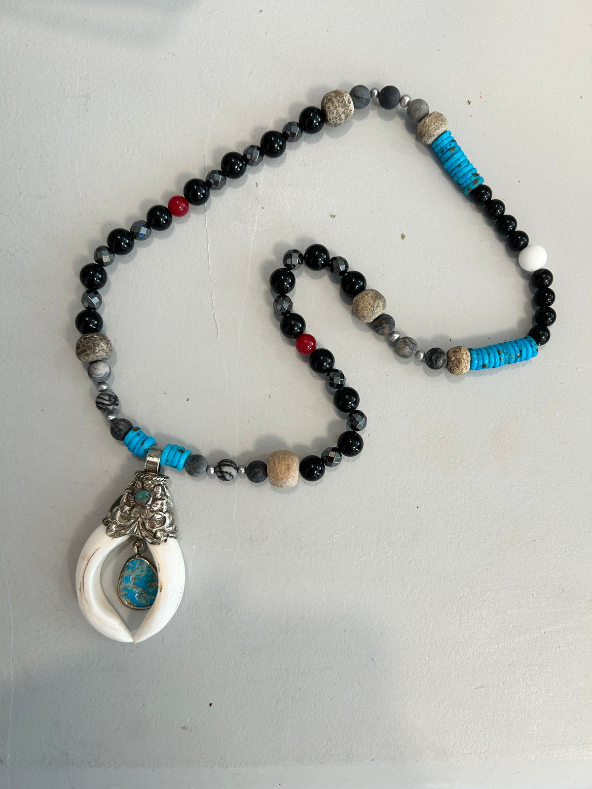 No. 60 Ivory Horn & Turquoise Sky necklace on gray surface