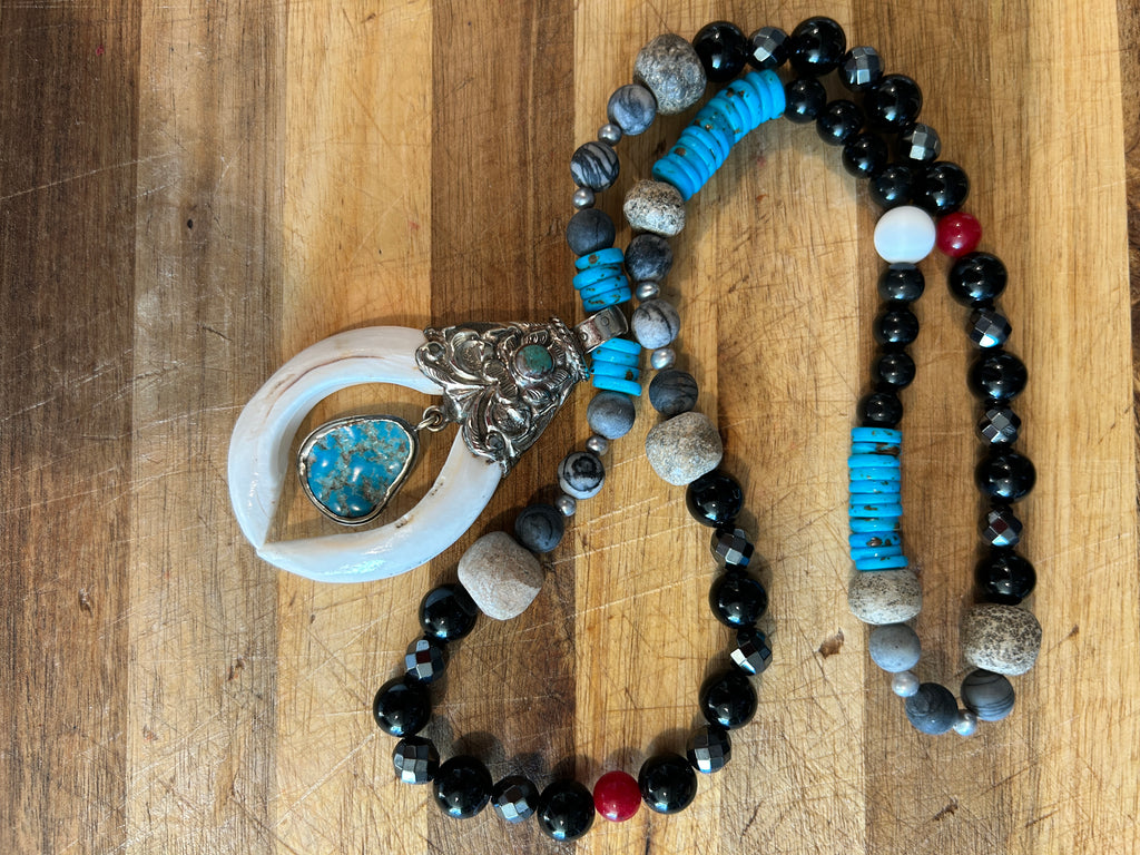 No. 60 Ivory Horn & Turquoise Sky necklace on white cushion