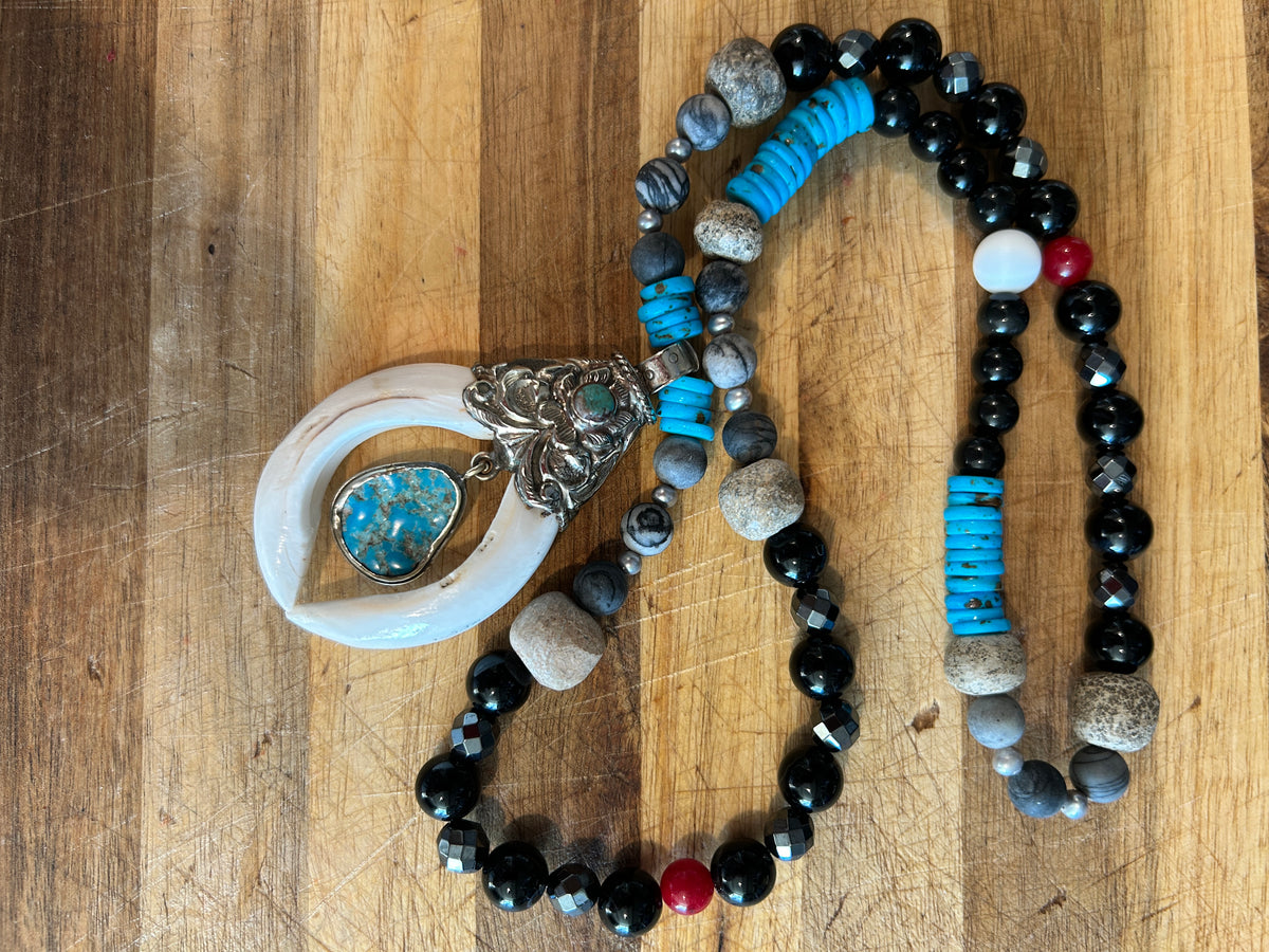 No. 60 Ivory Horn & Turquoise Sky necklace on white cushion