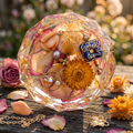 Rose Petal Dichroic Glass & Crystal Ring Resin Paperweight in romantic golden hour garden editorial scene