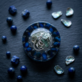 Lapis moon resin paperweight styled on dark slate with scattered lapis beads and cool moonlight lighting